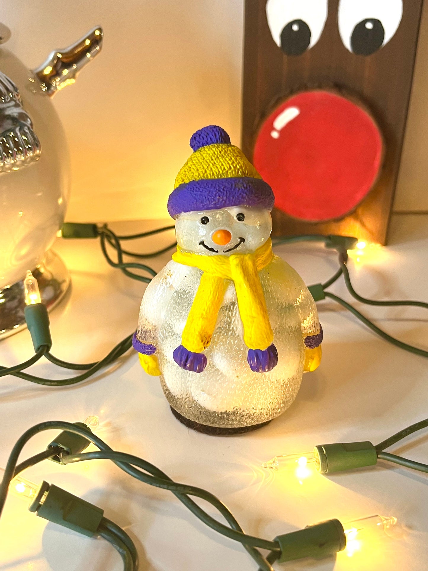 White snowmen with purple and yellow