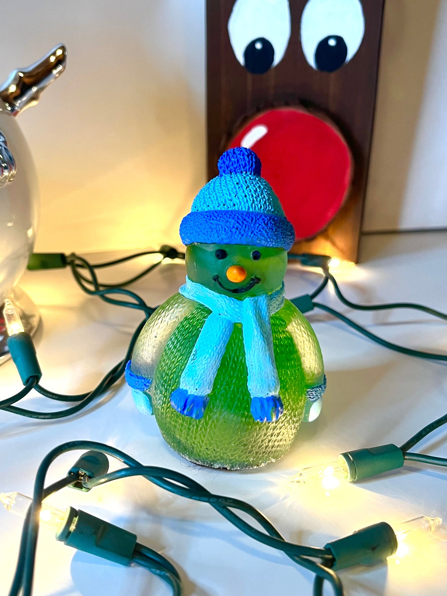 Green snowman with blue