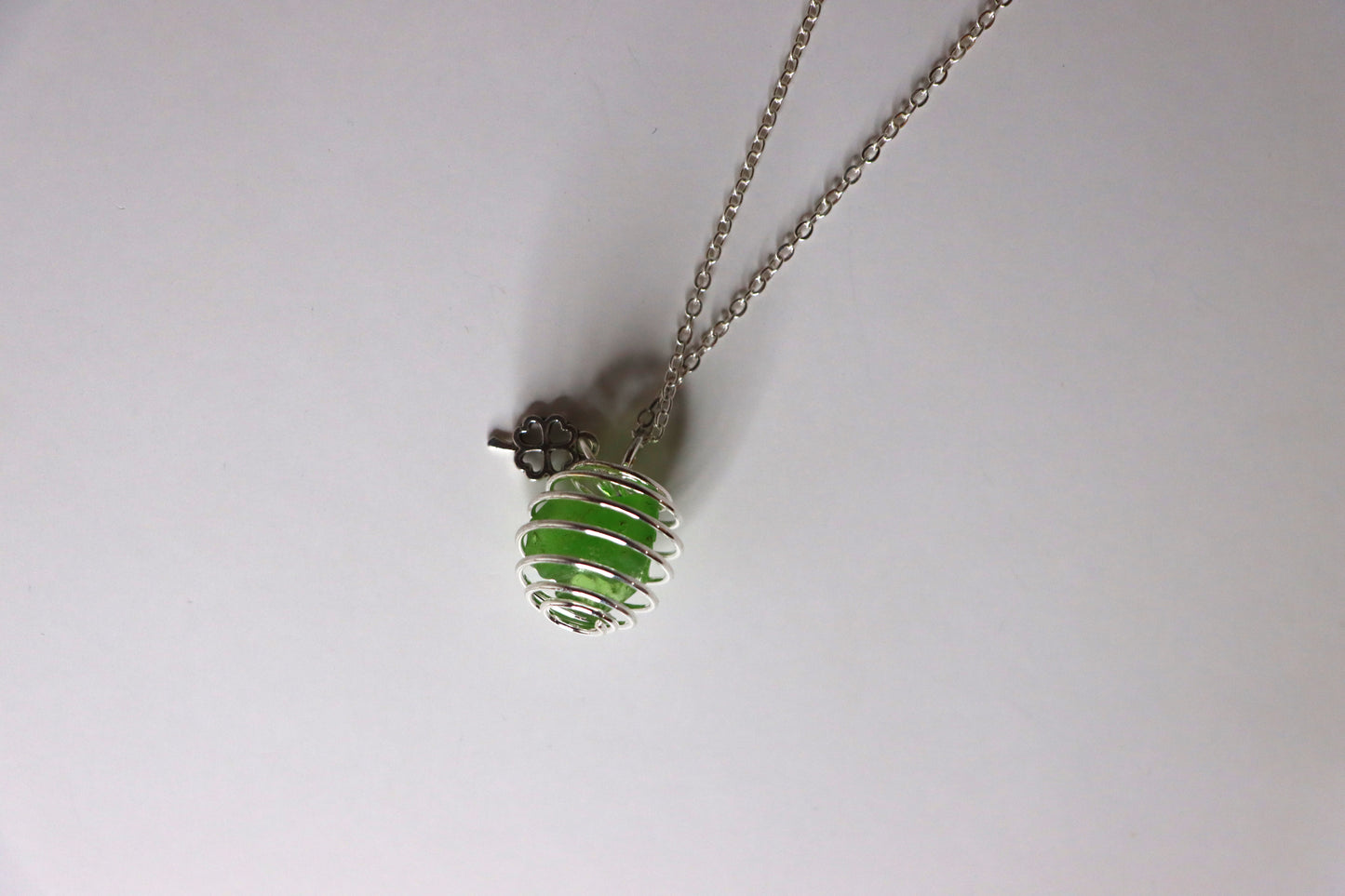 Green cage necklace with silver four leaf clover