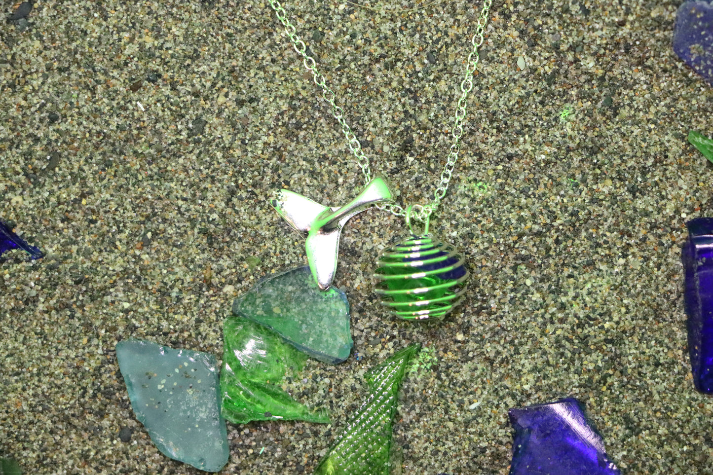 Green and blue cage necklace with whale tail